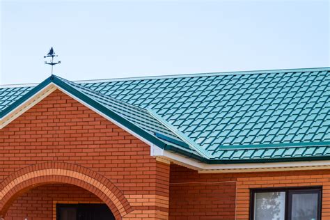 brick house with metal roof|matching brick and roof colors.